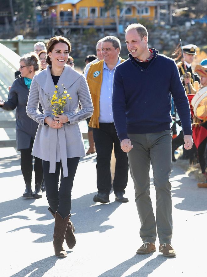 The Duchess wore a chic grey belted coat, paired with skinny jeans and brown boots on a visit to Carcross. Photo: Getty