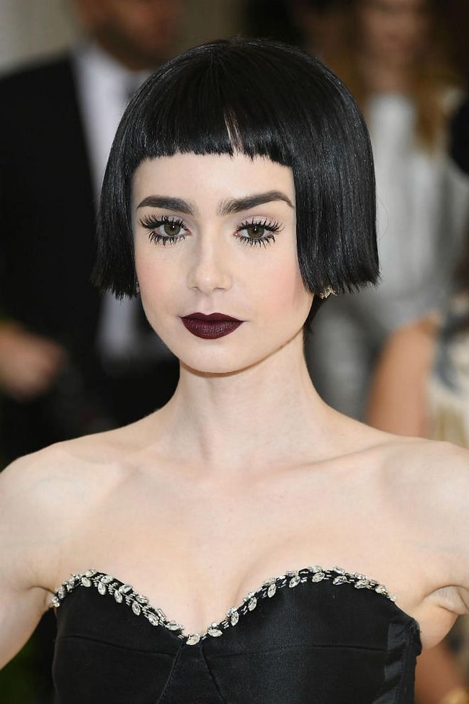 Collins' usual sweet girl aesthetic gets a dramatic makeover. Her lips were contrasted against her alabaster skin with a deep plum hue, sharply lined eyes and well-separated lashes. She finished the look with a sleek flapper girl-style bob with blunt bangs (Photo: Getty)