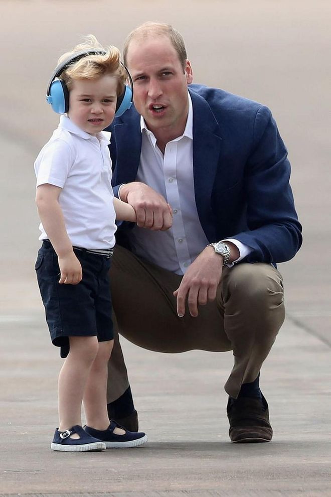 Prince William points out a plane to an excited Prince George during a visit to the Royal International Air Tattoo at RAF Fairford.

Photo: Getty