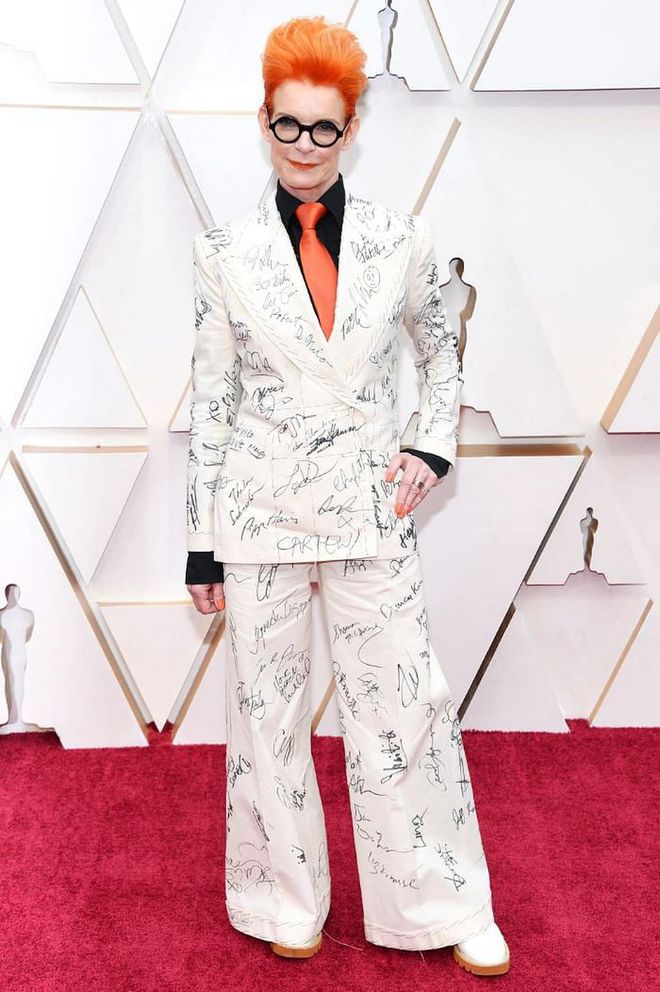 You might remember costume designer Sandy Powell making headlines with her ensemble at last week's Baftas, where she asked numerous A-listers to sign her white suit (which will be auctioned to raise money for a great cause). Powell chose to wear it again to the Academy Awards last night, where she no doubt picked up even more signatures.

Photo: Kevin Mazur / Getty