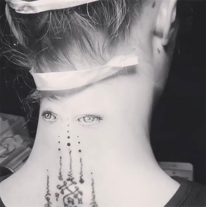 Cara Delevingne tapped NYC tattoo artist Bang Bang to ink a pair of eyes on the back of her neck. The art is beautiful, but also creepy. And also very real.