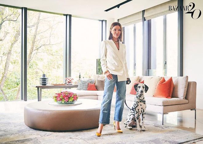 Lee and Neo in the living room. Lee wears her own Saint Laurent jacket and jeans, custom earrings, CELINE choker and bracelet, Harry Winston ring and Gianvito Rossi pumps.