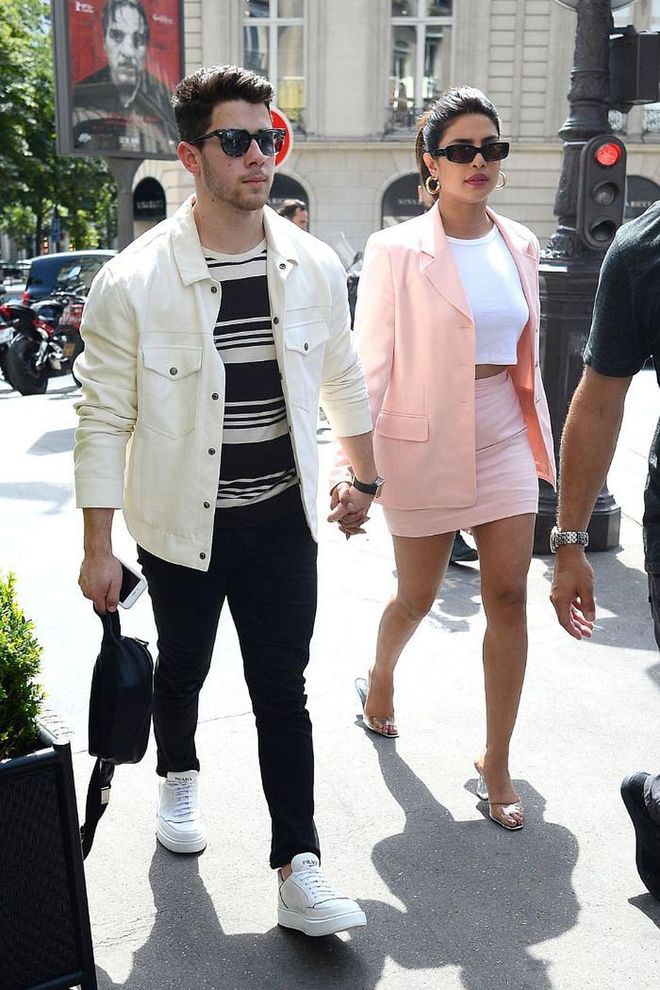 Serving '90s Clueless vibes, Priyanka went for a pink skirt suit and white crop top while out with Nick Jonas in France.

Photo: Splash News