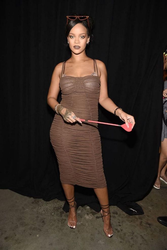 Rihanna adorns a brown ruched dress with a matching pair of shades backstage at the Savage x Fenty lingerie runway during New York Fashion Week.

Photo: Getty Images
