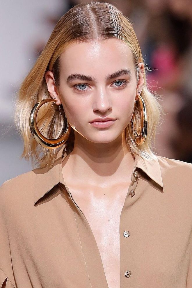 Easy, effortless, undone—there's no other way to describe the beauty seen at Michael Kors this season. Hair, keyed by Orlando Pita, was slicked back at the roots with mousse and tucked behind the ears.