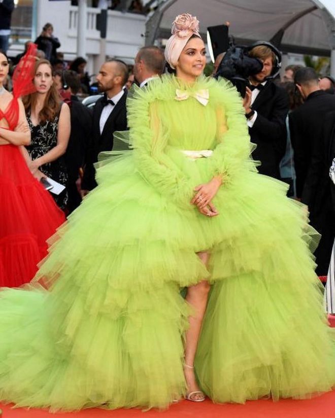 Deepika Padukone stepped onto the red carpet at the Pain And Glory premiere during the 2019 Cannes Film Festival in an all-encompassing lime tulle creation by Giambattista Valli. She matched the gown's pale pink bows with a floral turban headband by Emily-London.

Photo: Stephane Cardinale / Getty