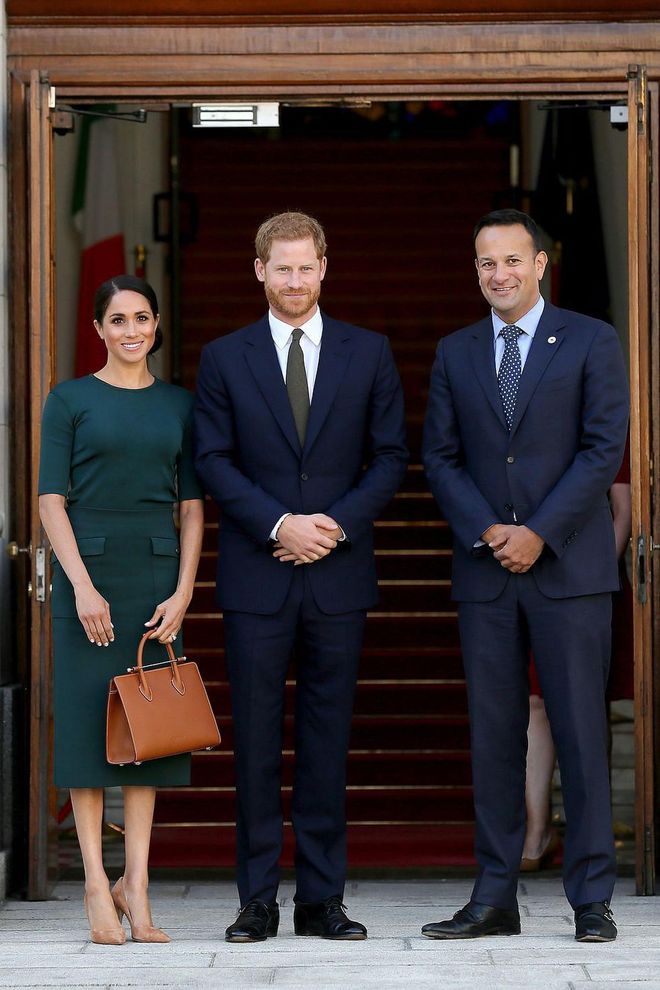 The trio poses together in the doorway.

Photo: Getty