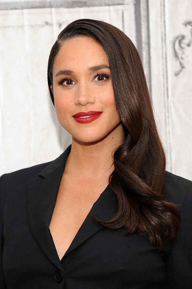 The Suits star's lipstick was a pop of color against her sleek, all-black outfit.
