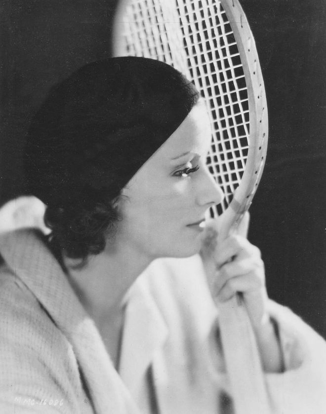 The elusive actress posed with a racket on the set of the 1929 silent film, The Kiss
Photo: Getty