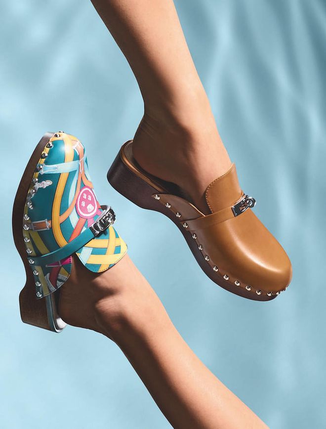 Clogs in Cavalcadour printed calfskin (left) or in Héritage calfskin, with Kelly buckle. (Photo: Arnaud Lajeunie/Hermès)