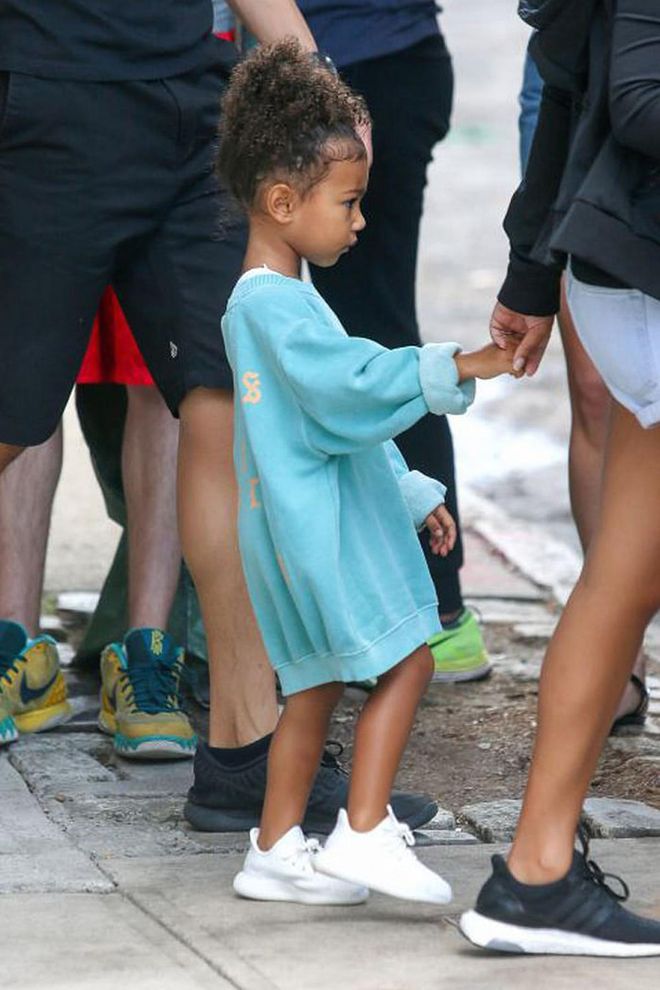 North West dons an outfit her mom and aunts are fond of—an oversized Yeezy sweatshirt worn as a dress plus Yeezy sneakers. Photo: AKM-GSI