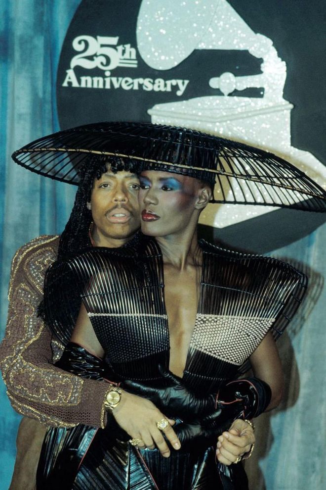 Leave it to Grace Jones to bring avant garde fashion onto the Grammy scene. The singer shut down the red carpet for the award show's 25th anniversary in an ultra wide-brim hat (which Rick James posed under) and matching black leather ensemble.