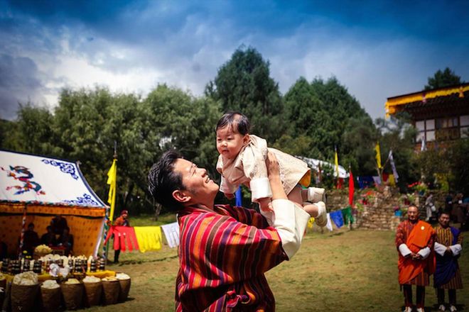 King Jigma lifts his son into the air at a beautiful valley in Bumthang, where a community had gathered to meet their Prince for the first time. Photo: Facebook 