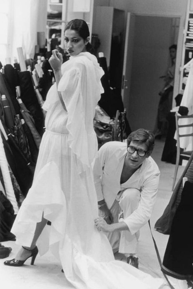 Yves Saint Laurent in his studio fitting a toile from the Autumn/Winter 1977 haute couture collection on the model Kirat