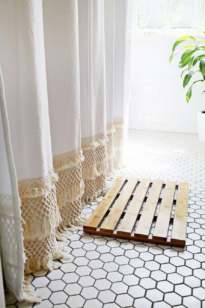 Live like you're on vacay all year round with cedar or pebble bath mats, rattan furnishings, spots of greenery, white walls and other soothing accents. Photo: Pinterest