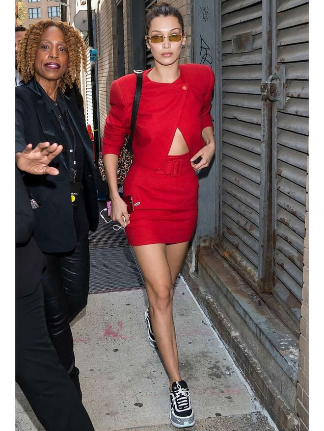 Offset the femininity of a skirt suit with a pair of chunky, throwback sneakers, as spotted on Bella Hadid.