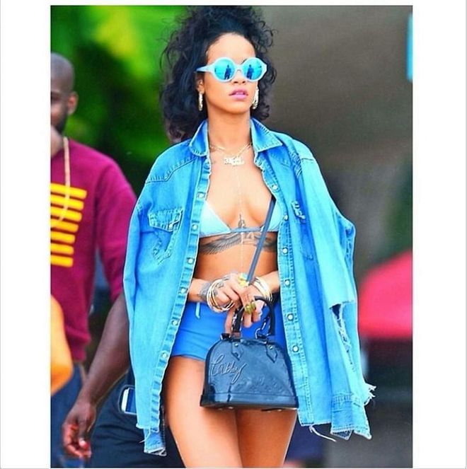 In her signature dressed-up/dressed-down style, Rihanna keeps this monochrome look from being boring by adding polarized lenses, giant earrings, and an oversized denim button-up shirt. <b>Zara Long Denim Jacket, S$98</b>