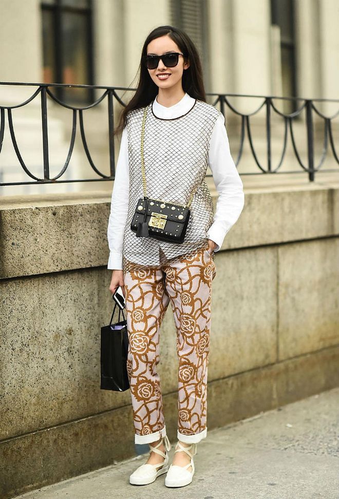 How to: Layered under a fishnet garment, matched with printed trousers. This look adds interesting details to enhance the versatility of a crisp white shirt. (Photo: Getty)