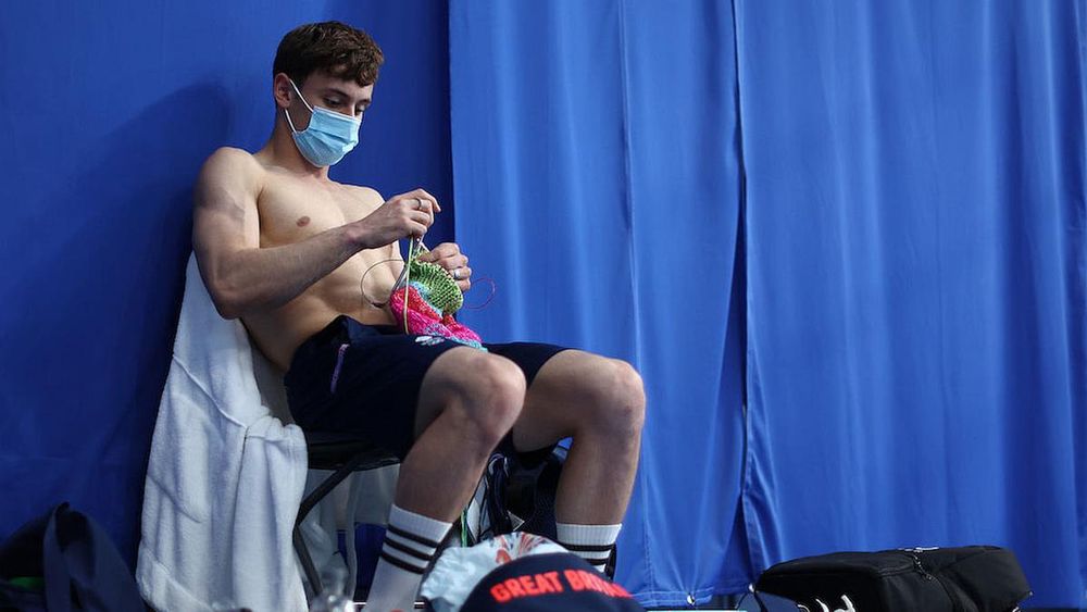 Thomas Daley of Team Great Britain is seen knitting before the Men's 10m Platform Final on day 15 of the Tokyo 2020 Olympic Games at Tokyo Aquatics Centre. (Photo: Clive Rose/Getty Images)