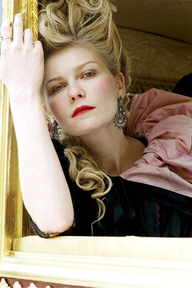 Kirsten Dunst played up the Queen of France's love of luxury, makeup and major hair in Sofia Coppola's modern retelling.