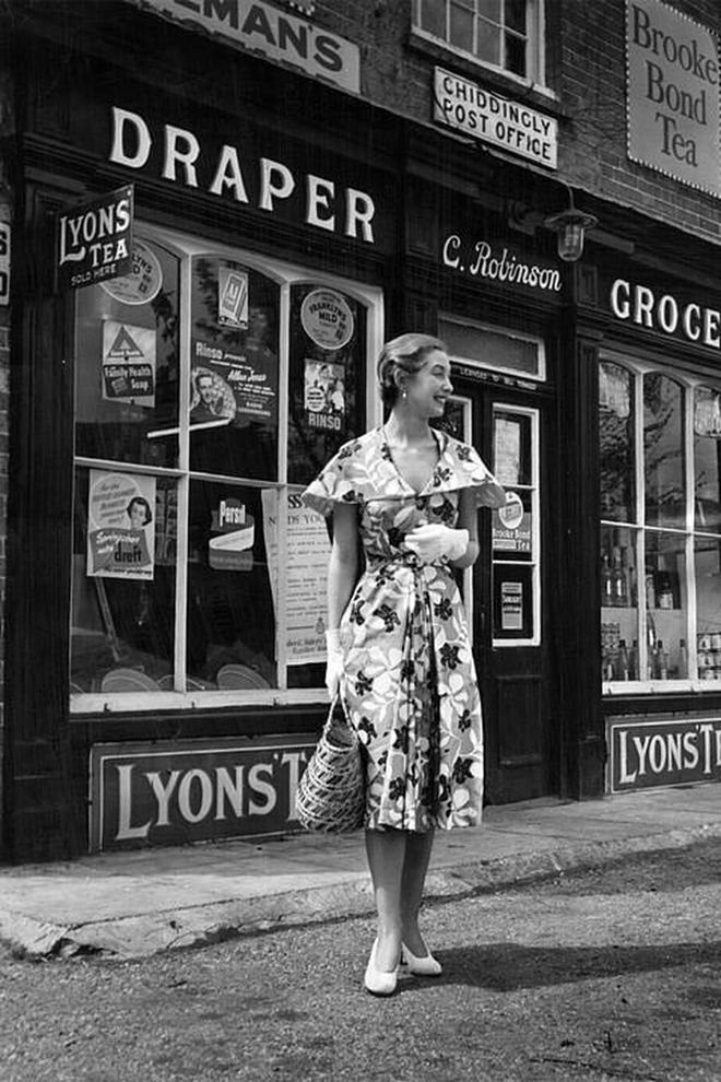 A young woman spotted in a print dress with detachable cape.

Photo: Getty