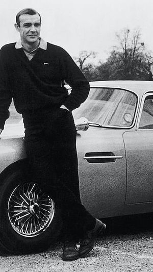 Actor Sean Connery, the original James Bond, is pictured here on the set of Goldfinger with one of the fictional spy's cars, a 1964 Aston Martin DB5. (Photo: Getty Images)