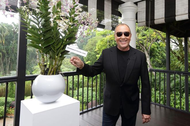 SINGAPORE - NOVEMBER 14:  American designer, Michael Kors poses for a photo as he puts the name plaque on the Dendrobium Michael Kors, an orchid that was named after him at the National Orchid Garden on November 14, 2016 in Singapore.  (Photo by Suhaimi Abdullah/Getty Images for Michael Kors)