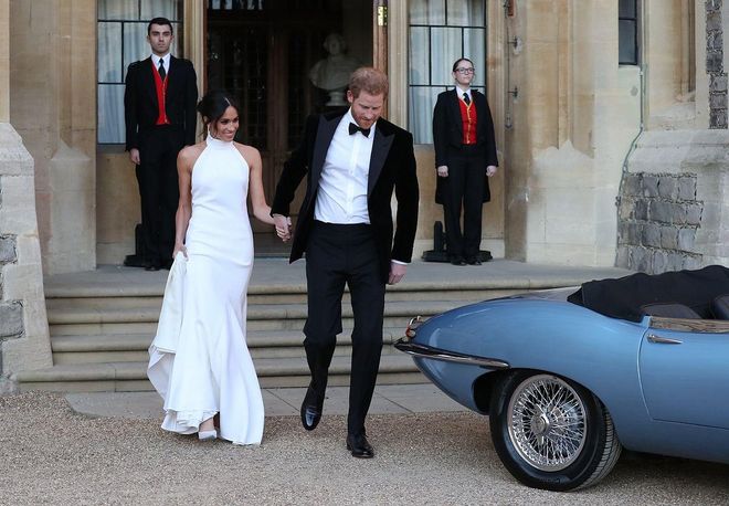 The newly married Prince Harry, Duke of Sussex and Meghan Markle, Duchess of Sussex, leave to attend an evening reception at Frogmore House.