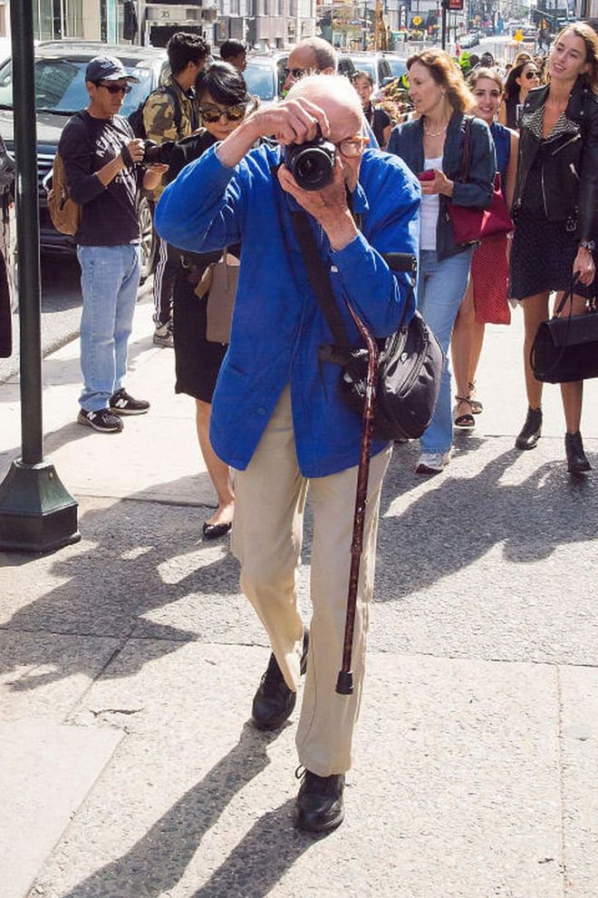 In June, the fashion world mourned the loss of beloved photographer, Bill Cunningham. The 87-year-old icon died following a stroke, creating a noticeably empty space in the industry—namely on the street style scene, during Fashion Week and at New York's most prestigious events. To commemorate him, Cunningham's go-to street style corner (57th and 5th) was renamed "Bill Cunningham Corner" in July and then during the first New York Fashion Week without him, photographers paid tribute to the legend by all wearing his signature blue jacket.