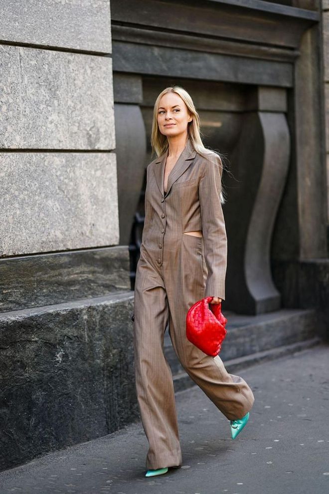 Because fall weather can be unpredictable, keep jumpsuits or coveralls on hand to make sure all your bases are covered. The one-step look is essential, regardless if you're working from home or not.

Photo: Edward Berthelot / Getty
