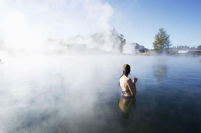 Take in Iceland's geothermal sites on this jam-packed day tour, starting with the steaming baths at the Secret Lagoon, followed by the Gullfoss Waterfall, Strokkur Geyser and Thingvellir National Park. Photo: Getty