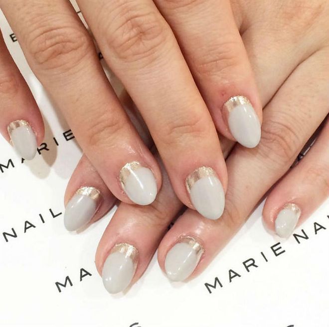 Gold along the cuticle gives this reverse French some edge while the milky white base and soft almond shape keep it elegant.  
@marienails