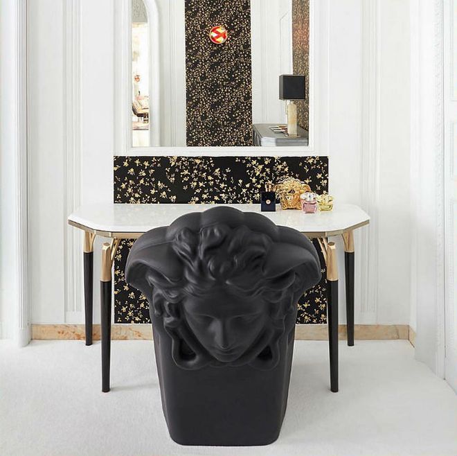 Versace Home's new collection includes furniture, tabletops, porcelain tableware and outdoor pieces in signature Versace aesthetic.

The brand's symbols are seen in key pieces, such as this chair with a sculptural Medusa motif on reverse. A statement piece and conversation starter, no less.