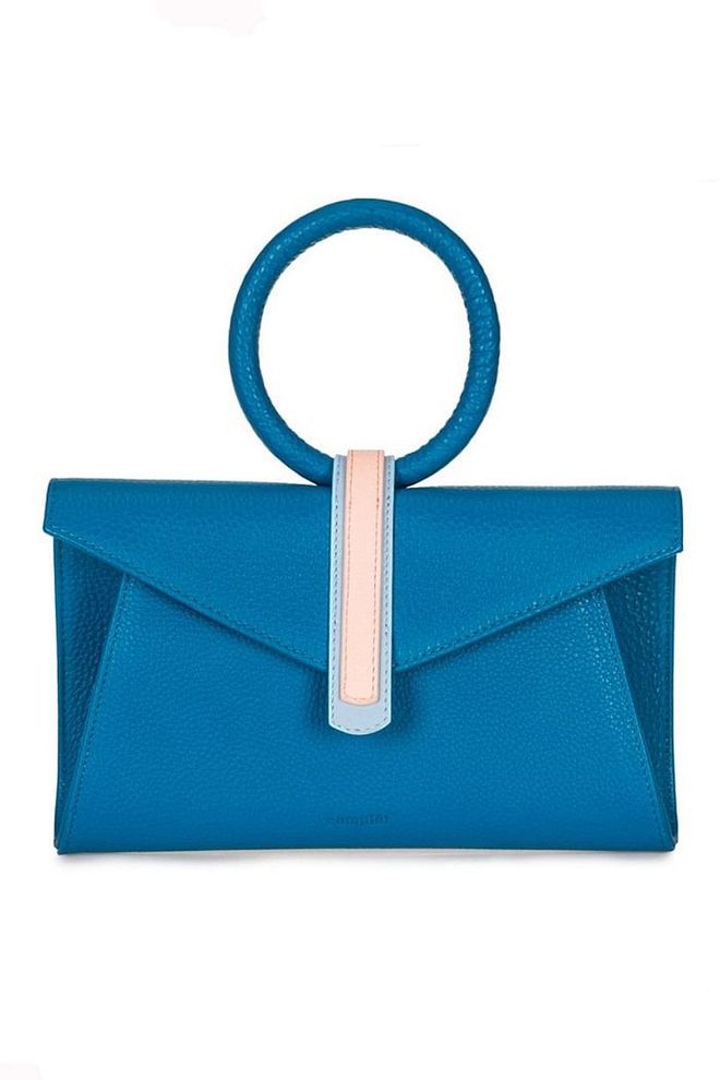 Tel Aviv-based bag brand Complet is slowly building a name for itself as a go-to for printed bags in geometric silhouettes. The vibrant turquoise colour of its Valery clutch will brighten any spring ensemble. 