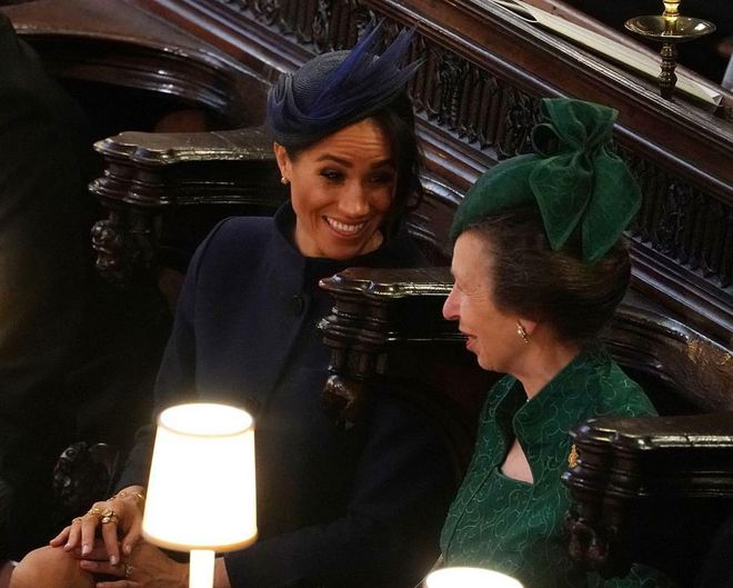 Meghan Markle and Princess Anne chat inside of St. George's Chapel as they wait for the ceremony to begin.