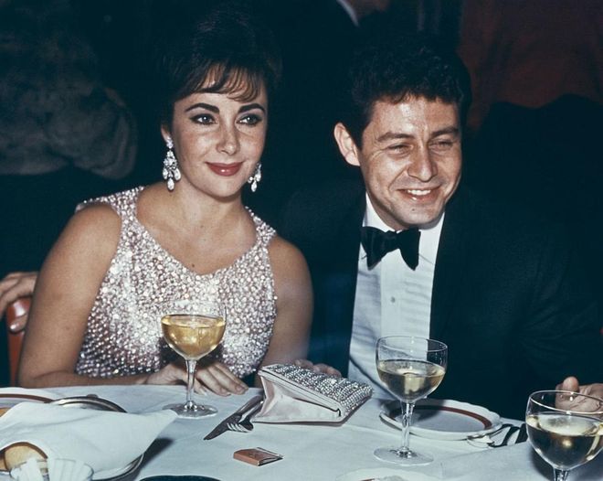 Renowned for her impressive jewelry collection, La Liz wore a crystal beaded dress and statement earrings for a dinner with then-husband Eddie Fisher in 1959. 
