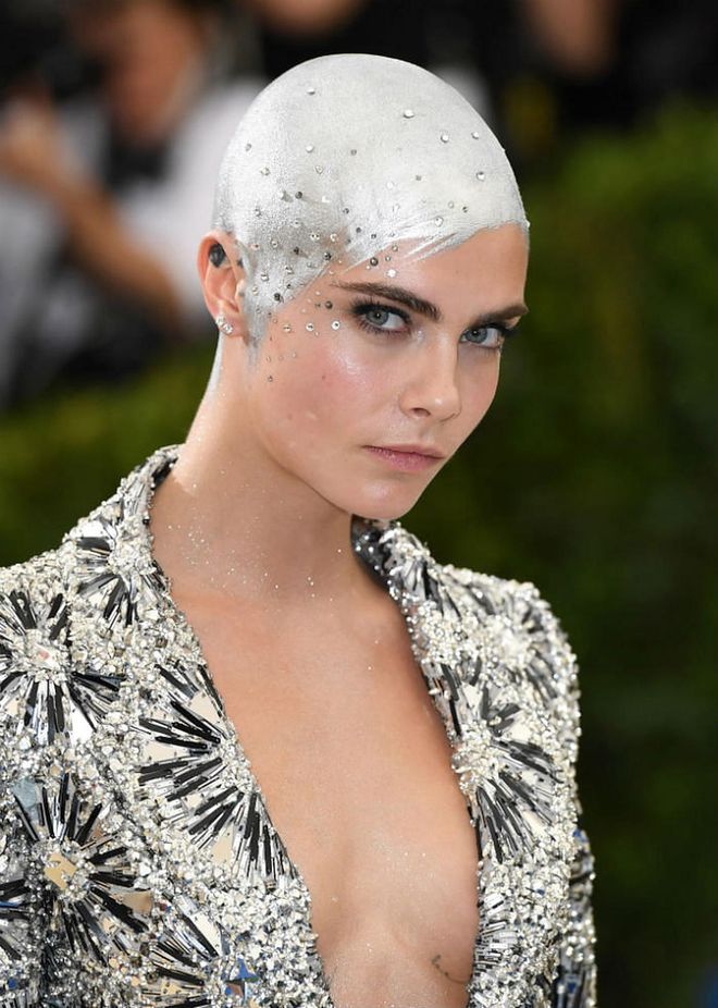 Trust Cara Delevigne to turn her freshly shaved head into an artwork of sorts with her scalp painted in silver and embellished with sparkly crystals (Photo: Getty)