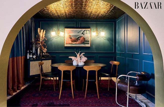 Highlights in the dining room include an American tin roof ceiling and a striking photographic print, Pink Wheels, from Austalian artist Kane Skennar.