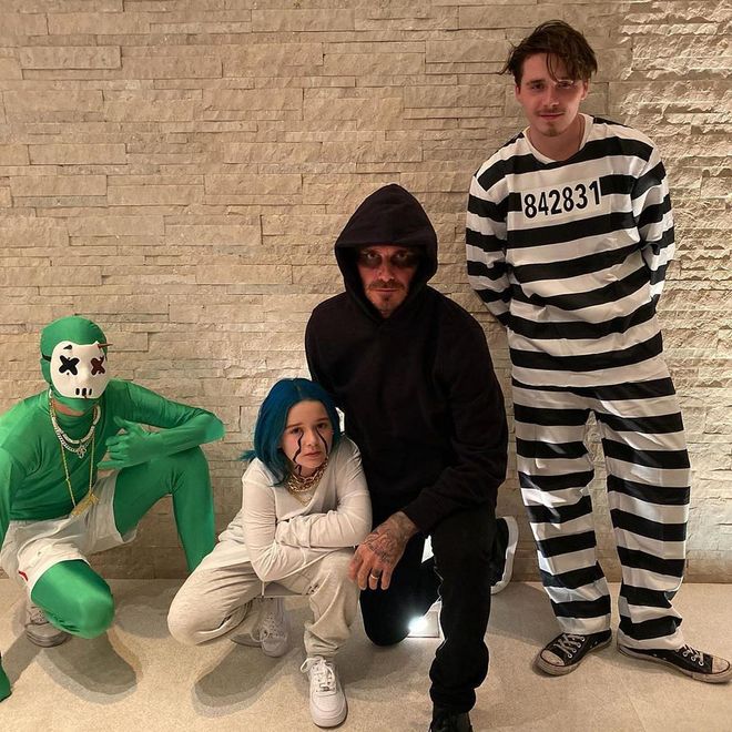 Victoria Beckham shared a photo of her husband David and kids Romeo, Harper, and Brooklyn happily posing together in costume. (Harper was Billie Eilish, the designer explained.)