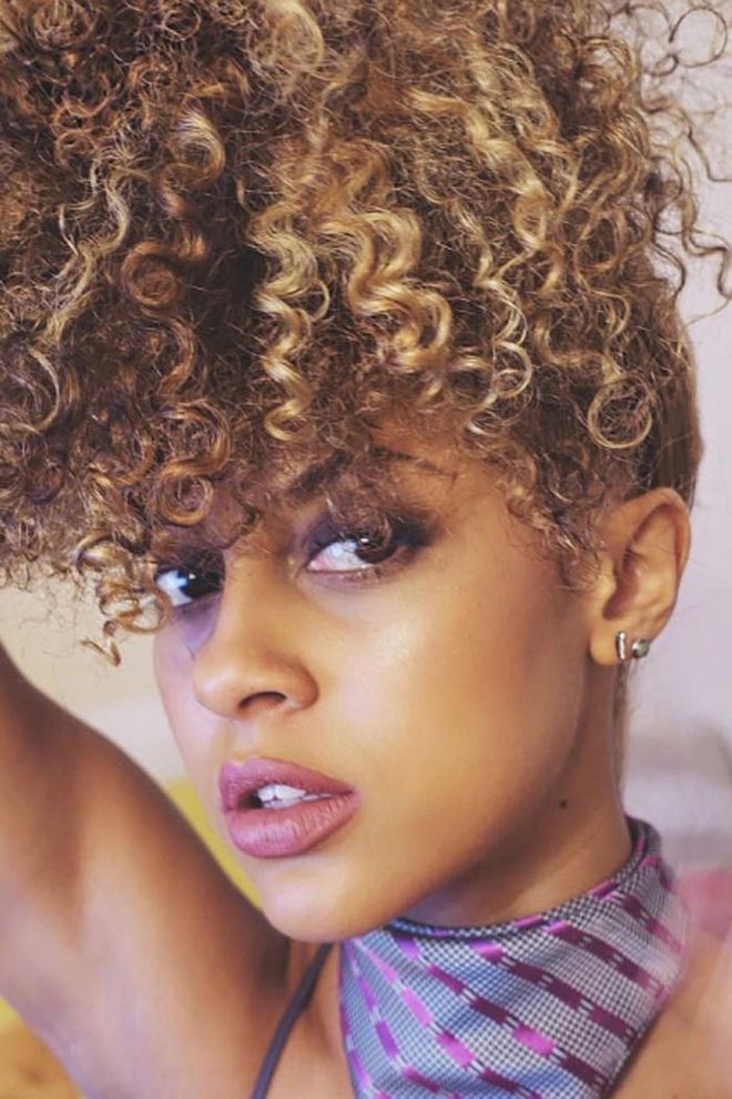 A look we spotted on one of our favorite Curly Girls to Follow on Instagram, Miss Britt piled on her signature honey-hued ringlets on top of her head in humidity-friendly fashion. The style is also a nighttime technique called "pineappling," which keeps curls in tact while you sleep.