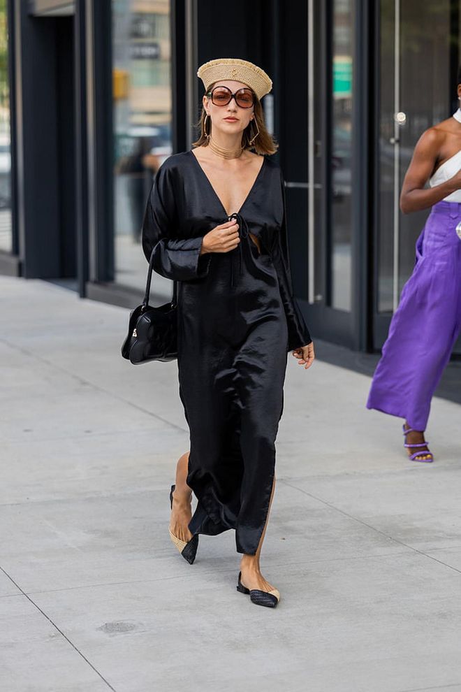 NEW YORK, NEW YORK - SEPTEMBER 09: A guest wears black silk dress, beige hat, sunglasses outside Bevza on September 09, 2023 in New York City. (Photo by Christian Vierig/Getty Images)