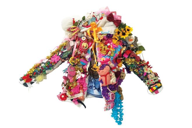 “This jacket is adorned with toys that are reminiscent of childhood memories. It took inspiration from my friend who describes his job as ‘something his five-year-old self would have never imagined doing.’ Professionally dressed with not a single hair out of place, one would never have imagined the fun-loving personality and crazy antics hidden behind this spiritless suit. The jacket weighs down the person wearing it, just like the responsibilities of the person growing up.”