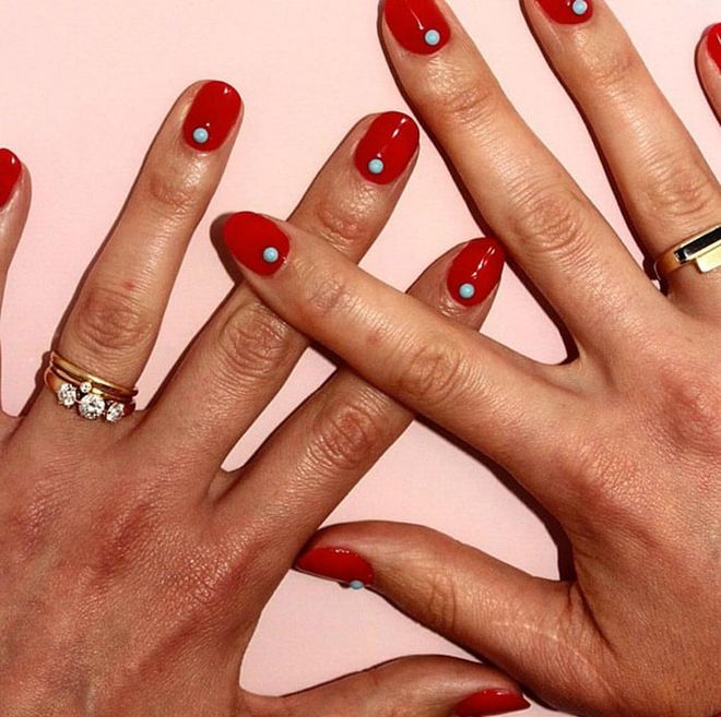 Put a special spin on a standard red look with tiny pearls placed at the base of the nail. @paintboxnails