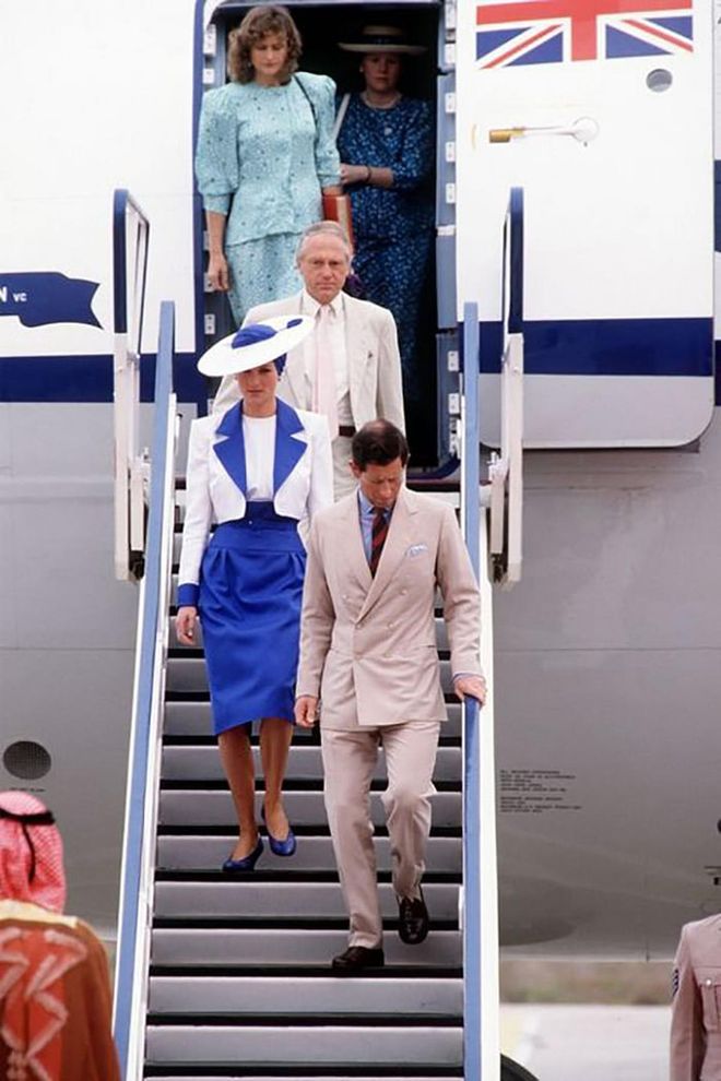Wearing a blue and white skirt suit and matching hat while arriving in Dubai with Prince Charles for the royal tour of The Gulf States.

