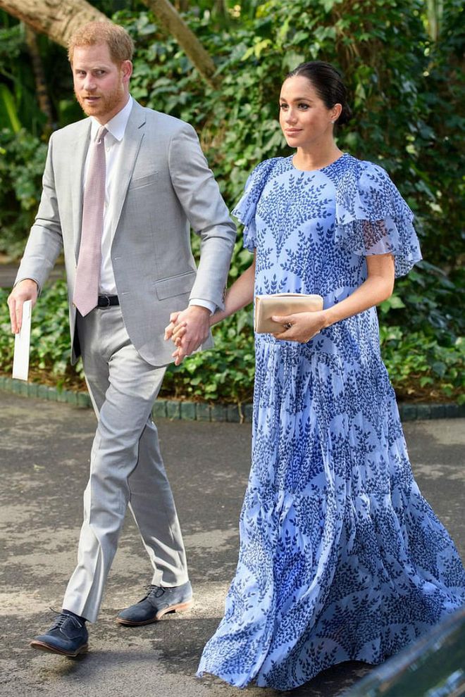 Prince Harry and Meghan Markle met Morocco's King Mohammed VI at his stunning royal residence for their final royal engagement in Morocco. The Duchess stunned in a custom floor-length printed blue dress by Carolina Herrera and a nude clutch, with her hair tied in a low bun.