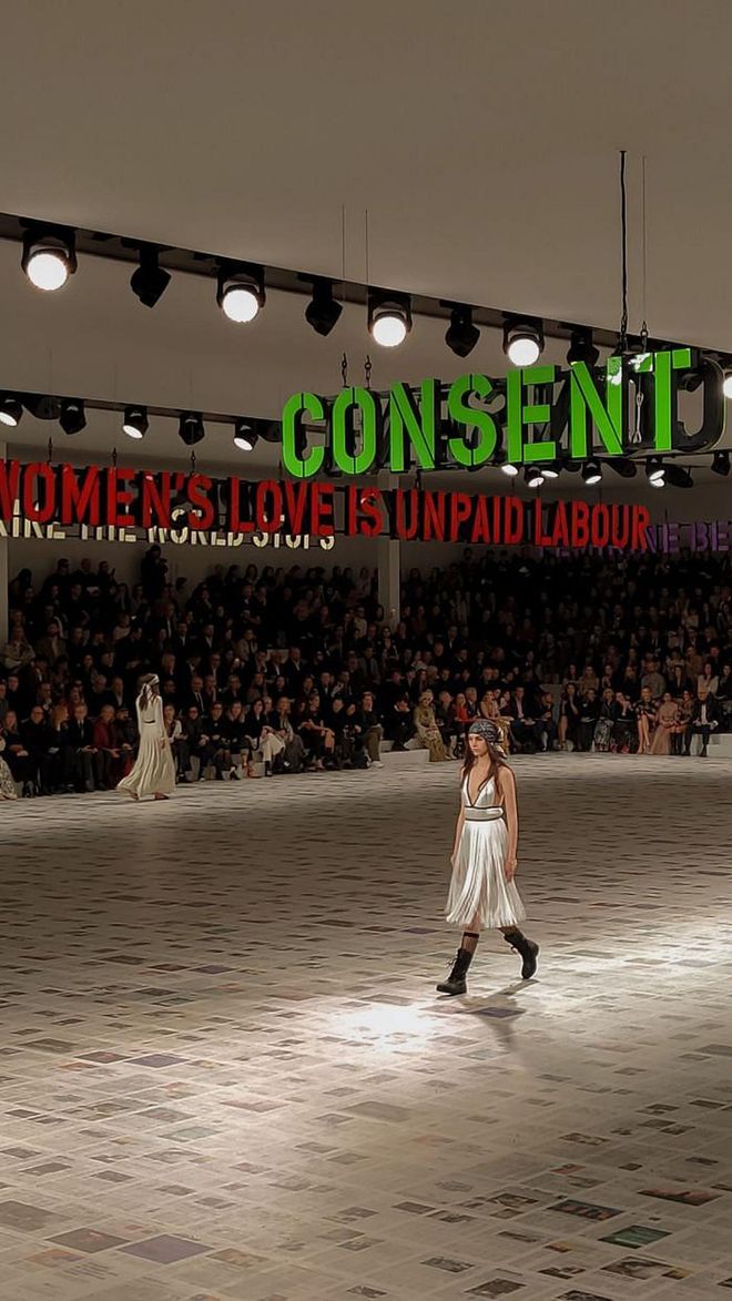 Thought provoking slogans of female empowerment suspended over this season's Dior show.