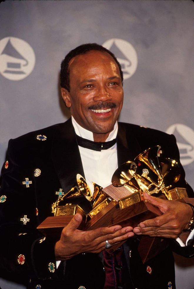 Quincy Jones poses for pictures at the 1991 Grammy Awards ceremony.