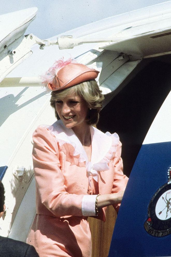 In a pink Belville Sassoon suit and hat while on her first official overseas visit to Australia. Photo: Getty