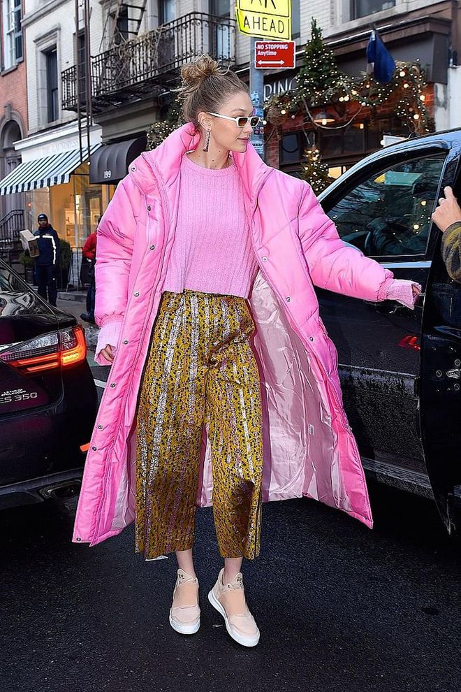 This bright pink Christina Ledang puffer coat is everything! Gigi went all out with a matching top too and a contrasting mustard yellow Christopher Bu pants. Obsessed! 