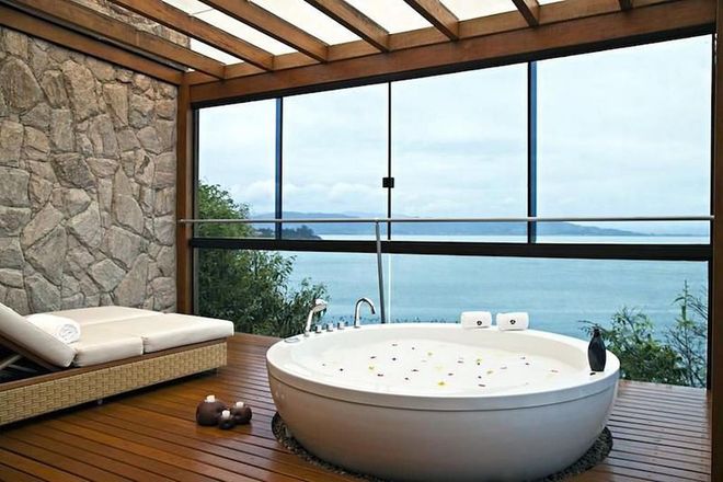 This ridiculously large tub found in the exclusive Pontos dos Ganchos resort looks out onto Brazil's Emerald Coast on the east of the country. While we're not sure if the colourful mix of flower petals are included, breathtaking views of the south Atlantic Ocean definitely are.